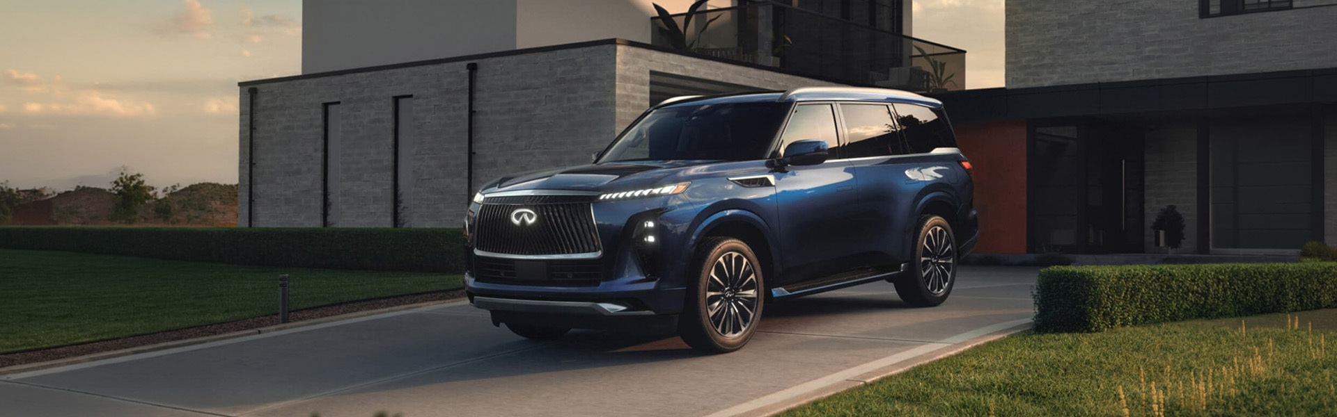 INFINITI QX80 SUV parked in front of a residential house in Lexington, KY.